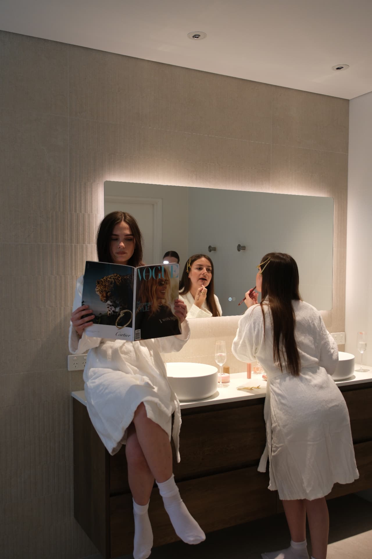Residents relaxing beside the illuminated bathroom mirror